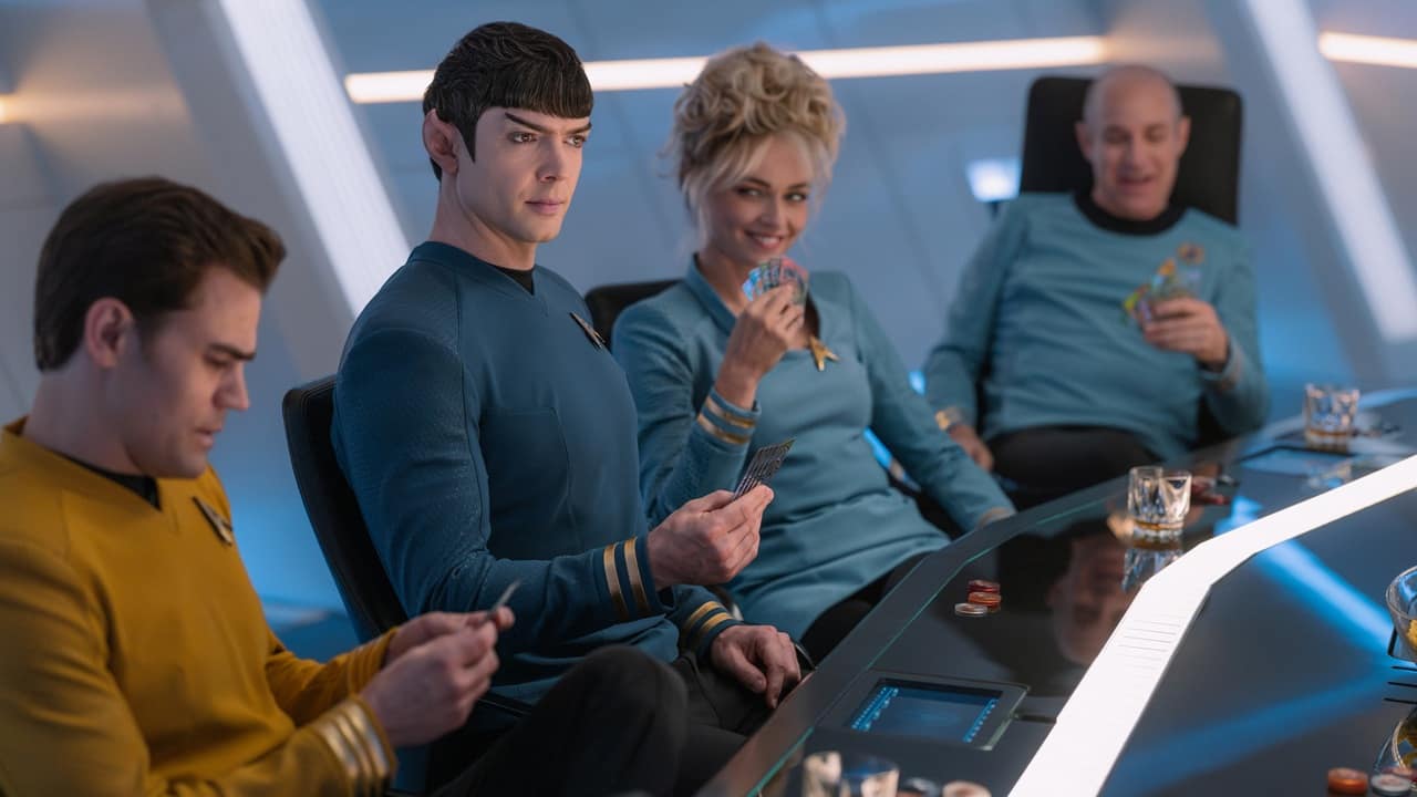 Kirk Spock Chapel and Boyce sit at a table with drinks playing cards from Star Trek Strange New Worlds