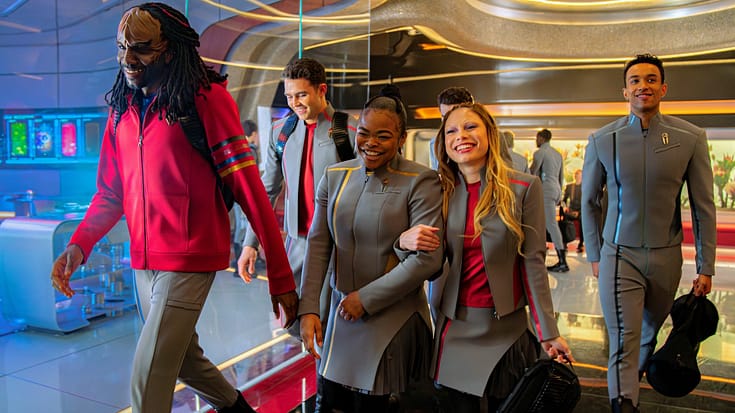 The young cast of Star Trek Starfleet Academy walking in a hallway smiling and laughing