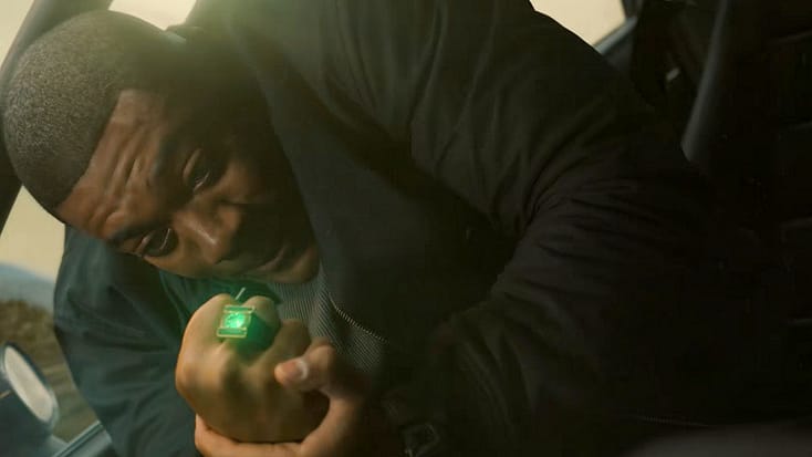 John Stewart desperately activating the Green Lantern ring as his car crashes from Lanterns